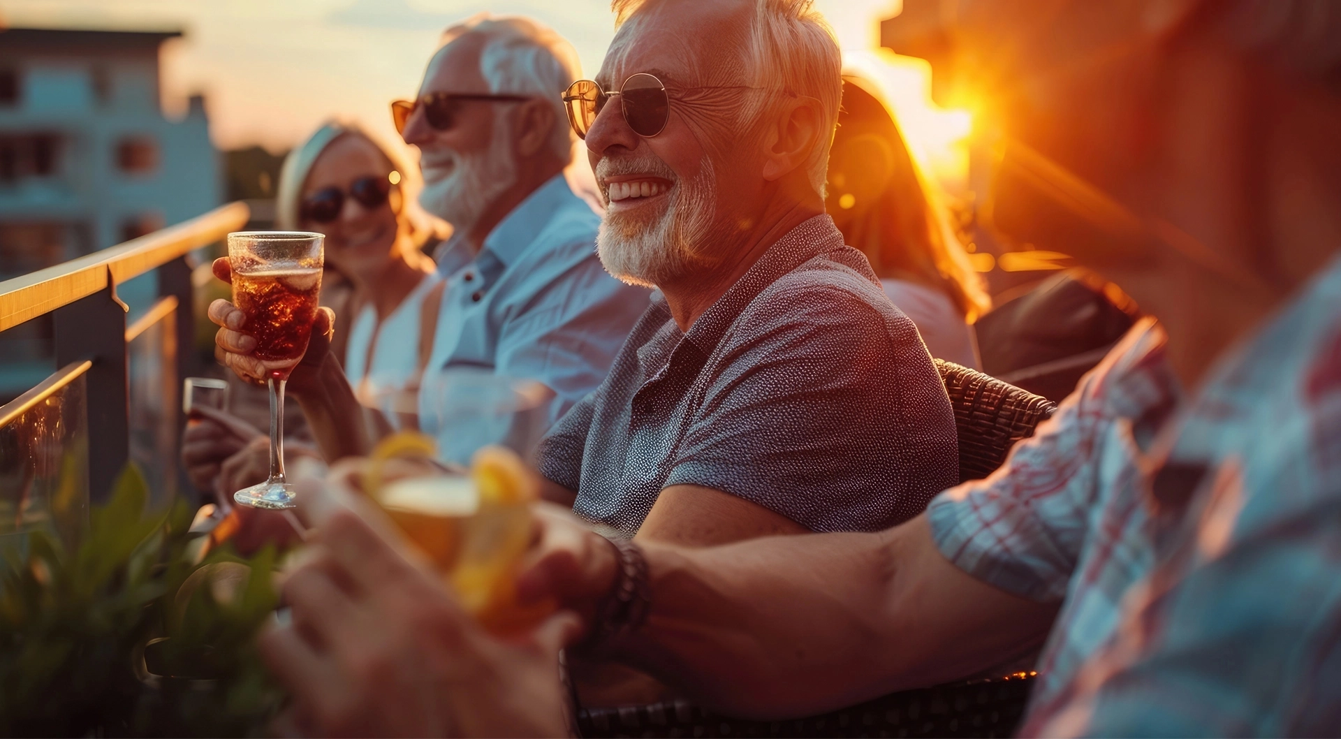 Close-up of seniors enjoying drinks on a balcony